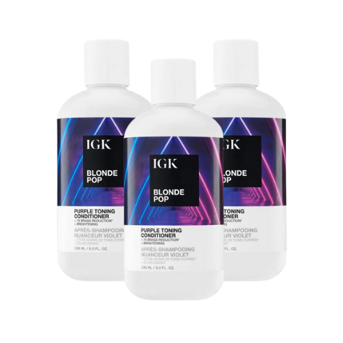 Three bottles of IGK Blonde Pop purple toning conditioner.