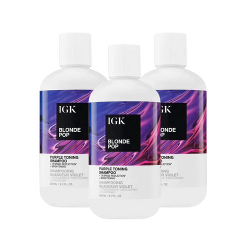 Three bottles of IGK Blonde Pop purple toning shampoo.