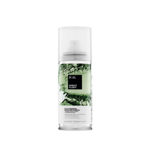 A bottle of IGK Direct Flight dry shampoo with green design elements.