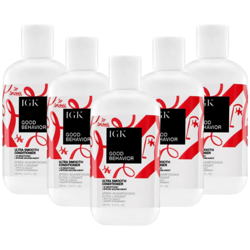 Five bottles of IGK Ultra Smooth Conditioner with red and white design on labels.