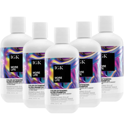 Five bottles of IGK More Life Color Extending Gloss Shampoo with vibrant label designs.