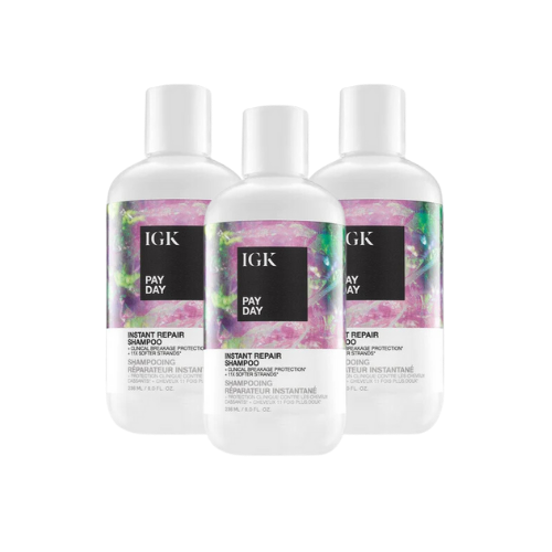 Three bottles of IGK Pay Day Instant Repair Shampoo with colorful labels.